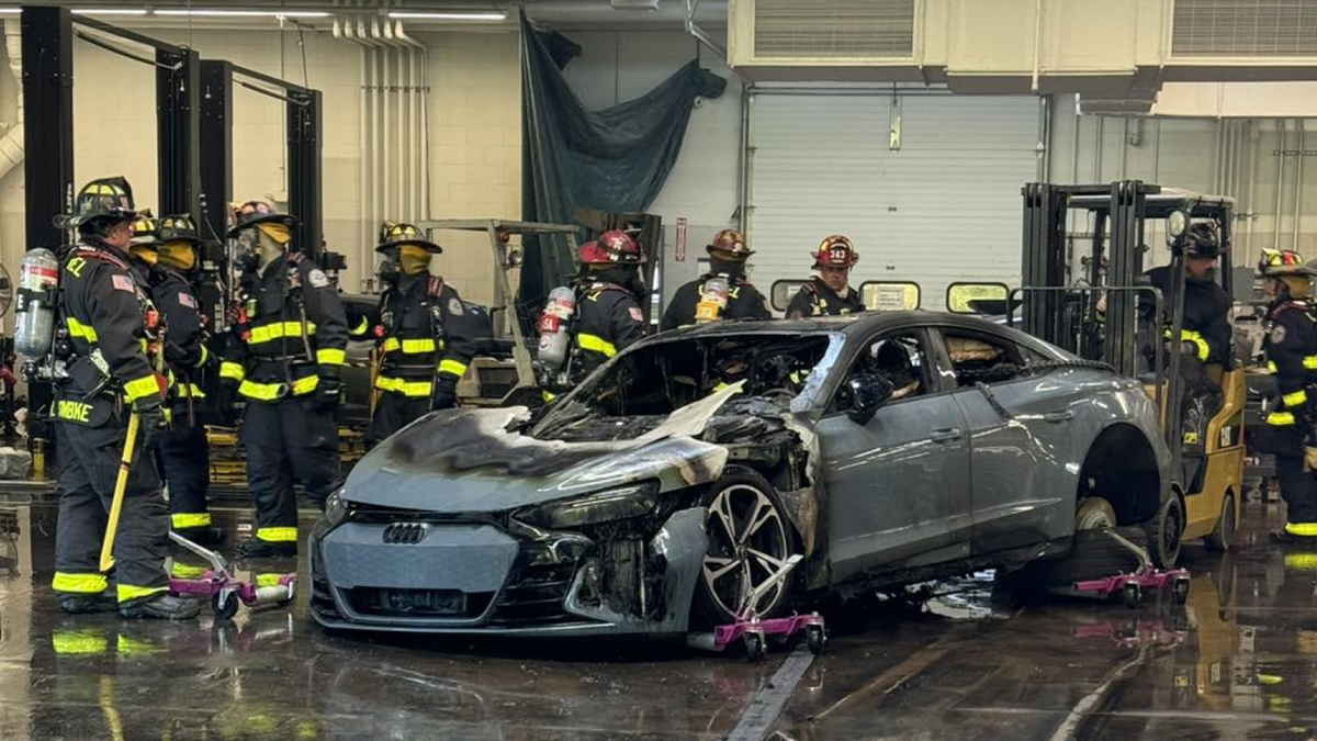 Firefighters Wheel Burning Audi EV Outside After It Caught Fire In Service Center